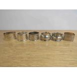 Six various silver napkin rings, including one inscribed "George",