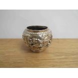 A Chinese silver pot with dragon detail, marks to base, 6cm tall, 8cm diameter,