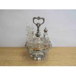 A silver plate seven piece cruet on revolving stand