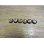 A set of six buttons depicting hunting scenes,