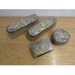 A silver match box case, heat form trinket box, and two silver topped brushes, all a/f,