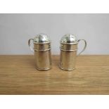 A pair of Pepper pots modelled as flour dredges Birmingham 1901 William Aitkin, dented,