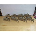 A set of eight Italian plated fish menu holders