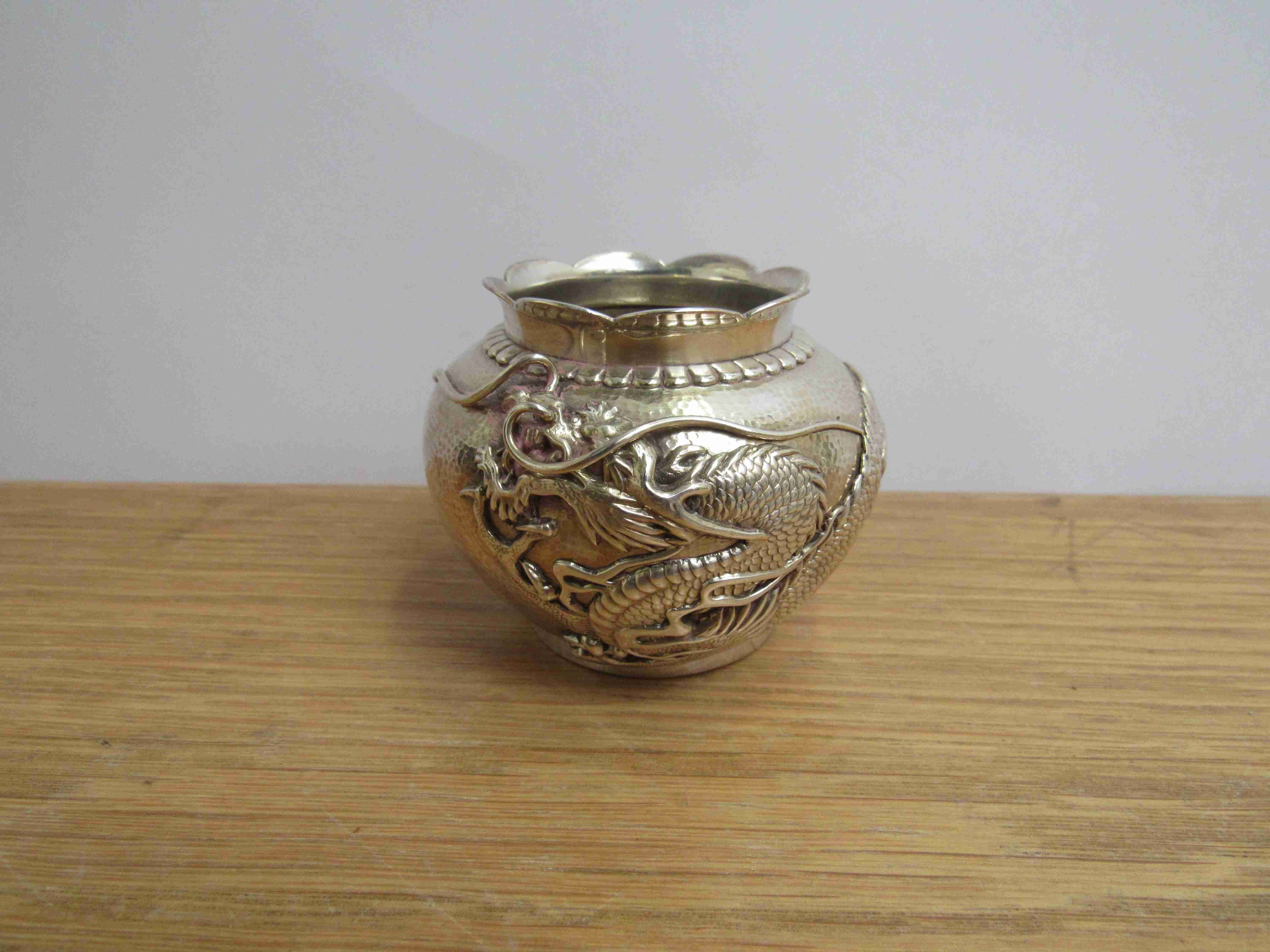 A Chinese silver pot with single dragon, hammered body, marks to base, 5.