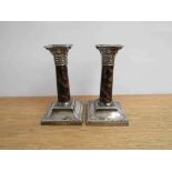 A pair of Reid & Sons silver candlesticks with tortoiseshell column, 15cm tall,