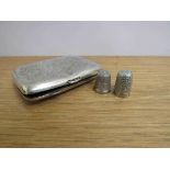 Two silver thimbles and a silver cigarette case dented,