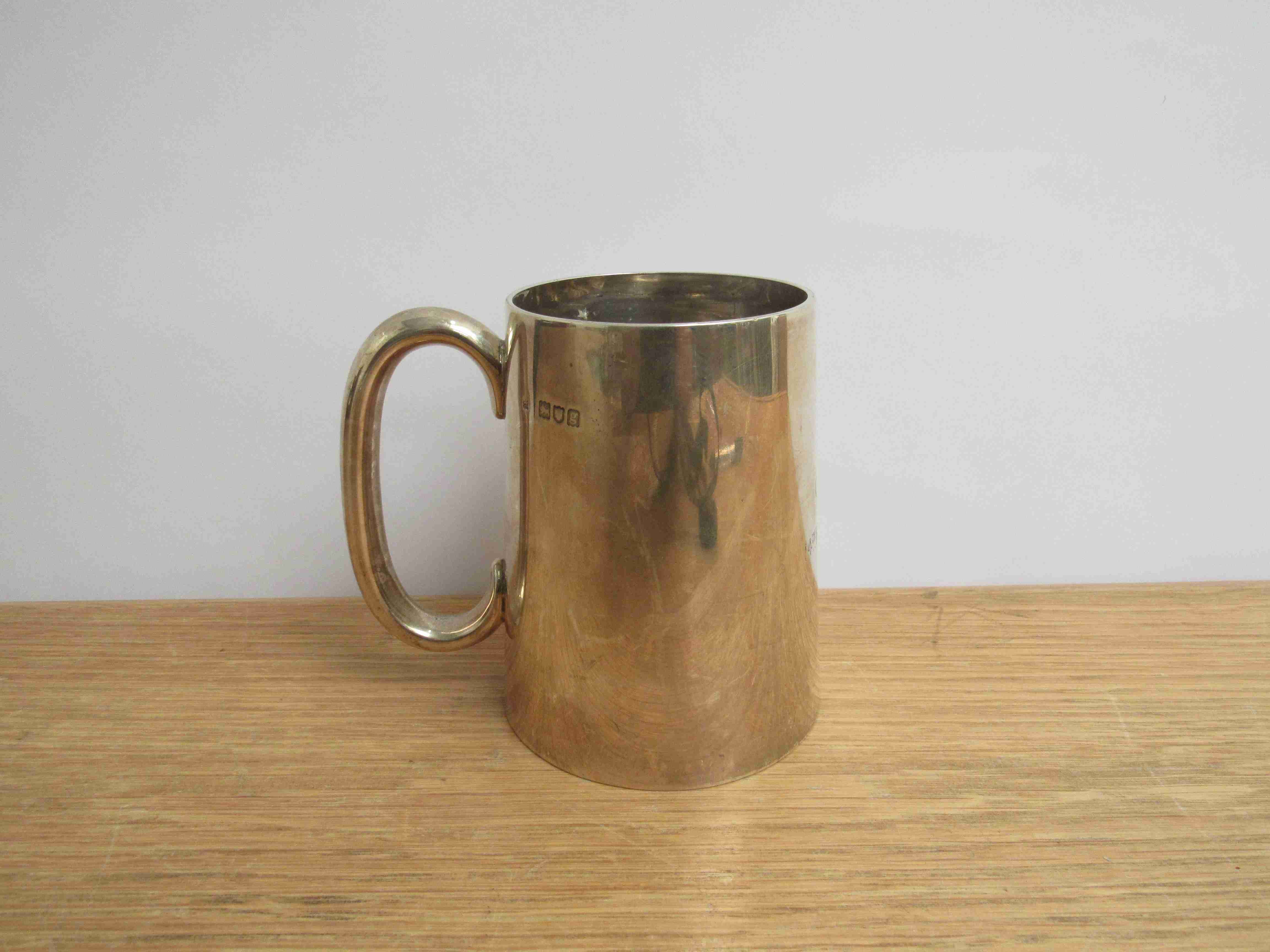 An Edwardian silver tankard of plain tapered form, maker indistinct, London 1902,