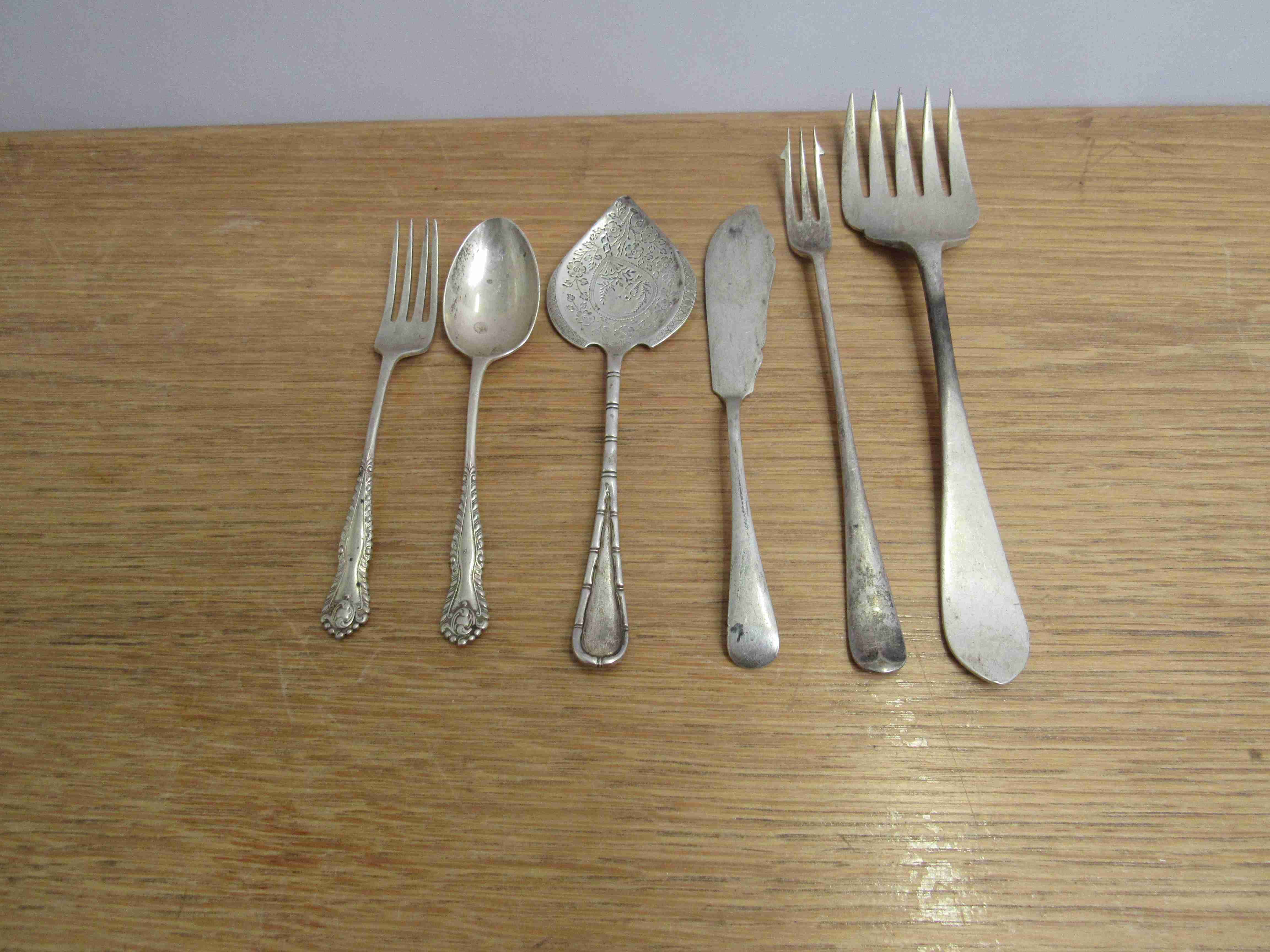 Mixed silver flatware including trident fork, butter knife,