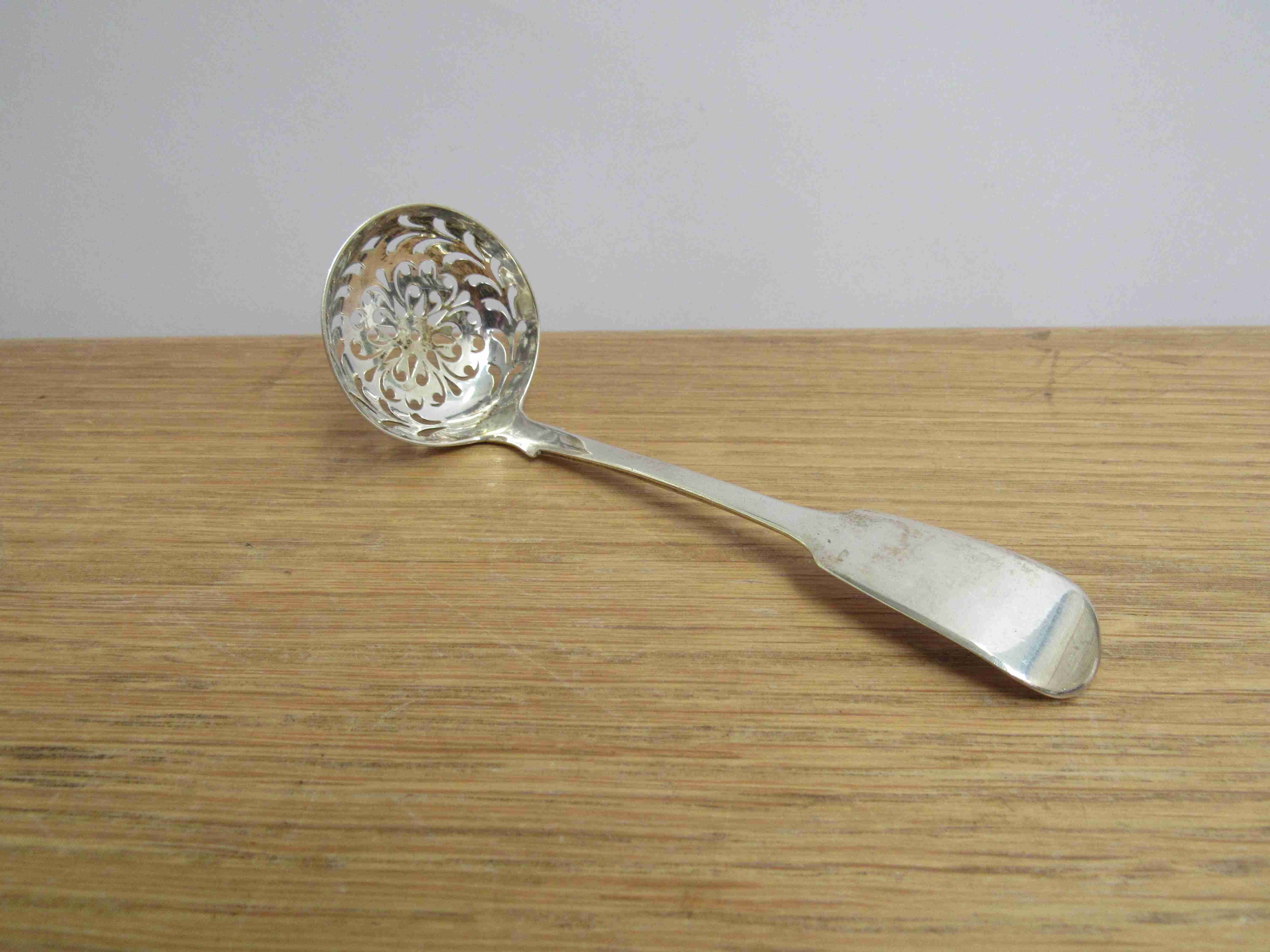 An early Victorian silver "Fiddle" pattern sifting spoon, London 1838,