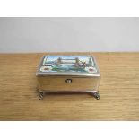 A silver enamelled box on scrolled/acanthus feet and hinged lid with enamelled scene of Tower