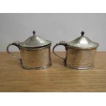 A pair of Thomas Bradbury and Sons Ltd silver mustard, London 1913,