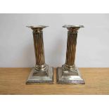 A pair of Edwardian Thomas A Scott silver column candlesticks.