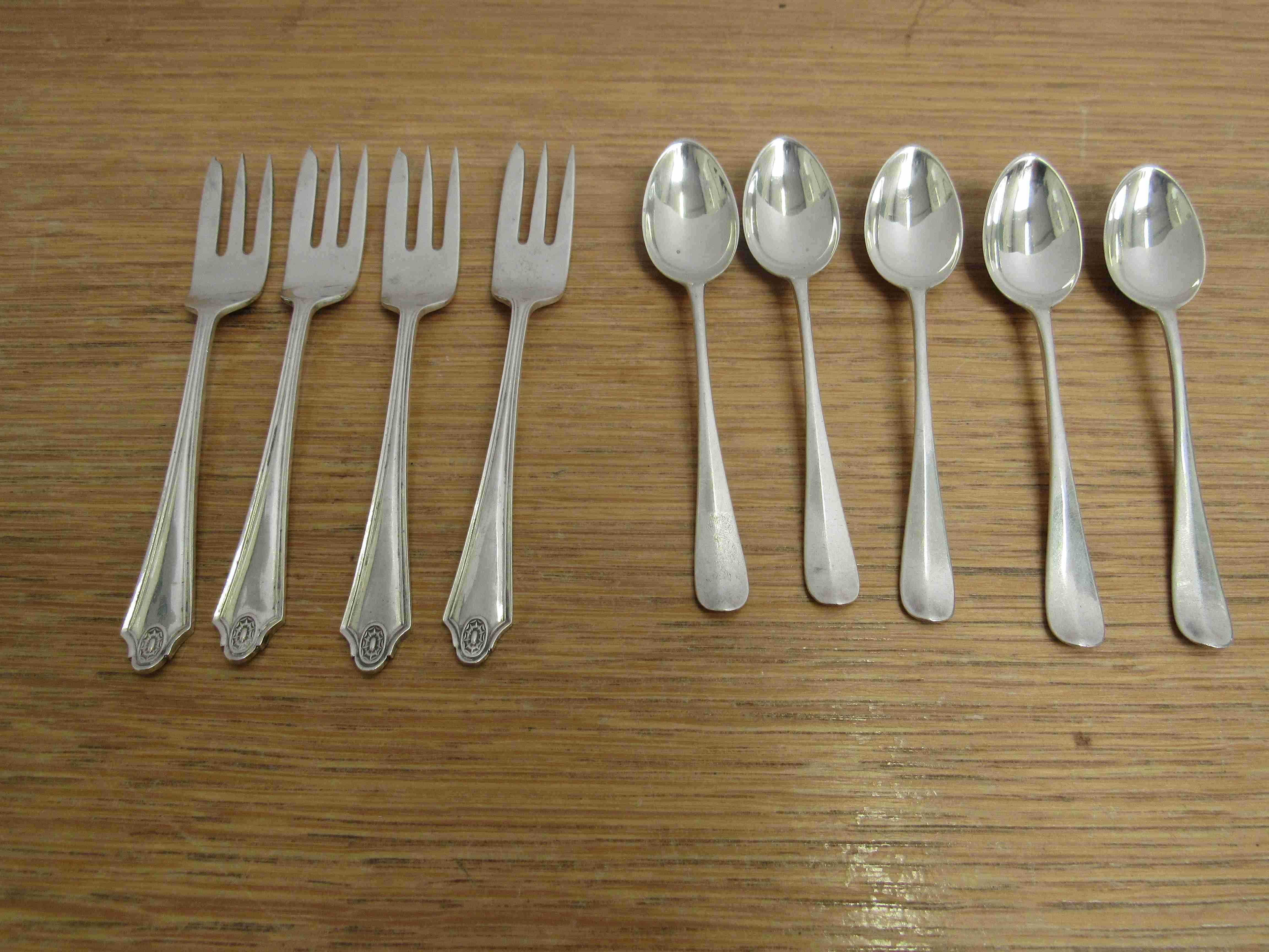 Four silver cake forks and five silver rat tail teaspoons Birmingham 1928 & 1915,