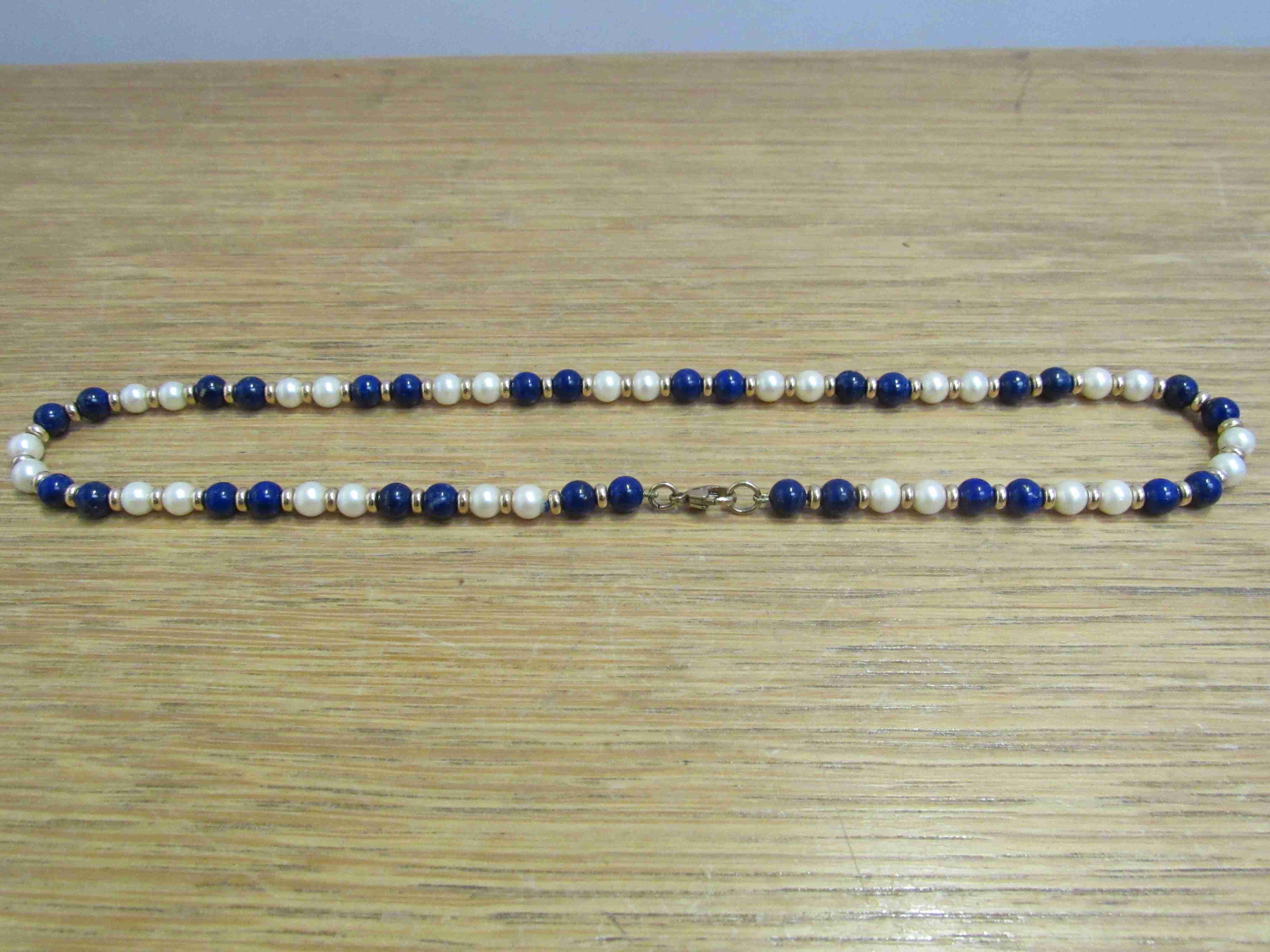 A Lapis Lazuli, pearl and gold bead necklace with 9ct gold clasp,