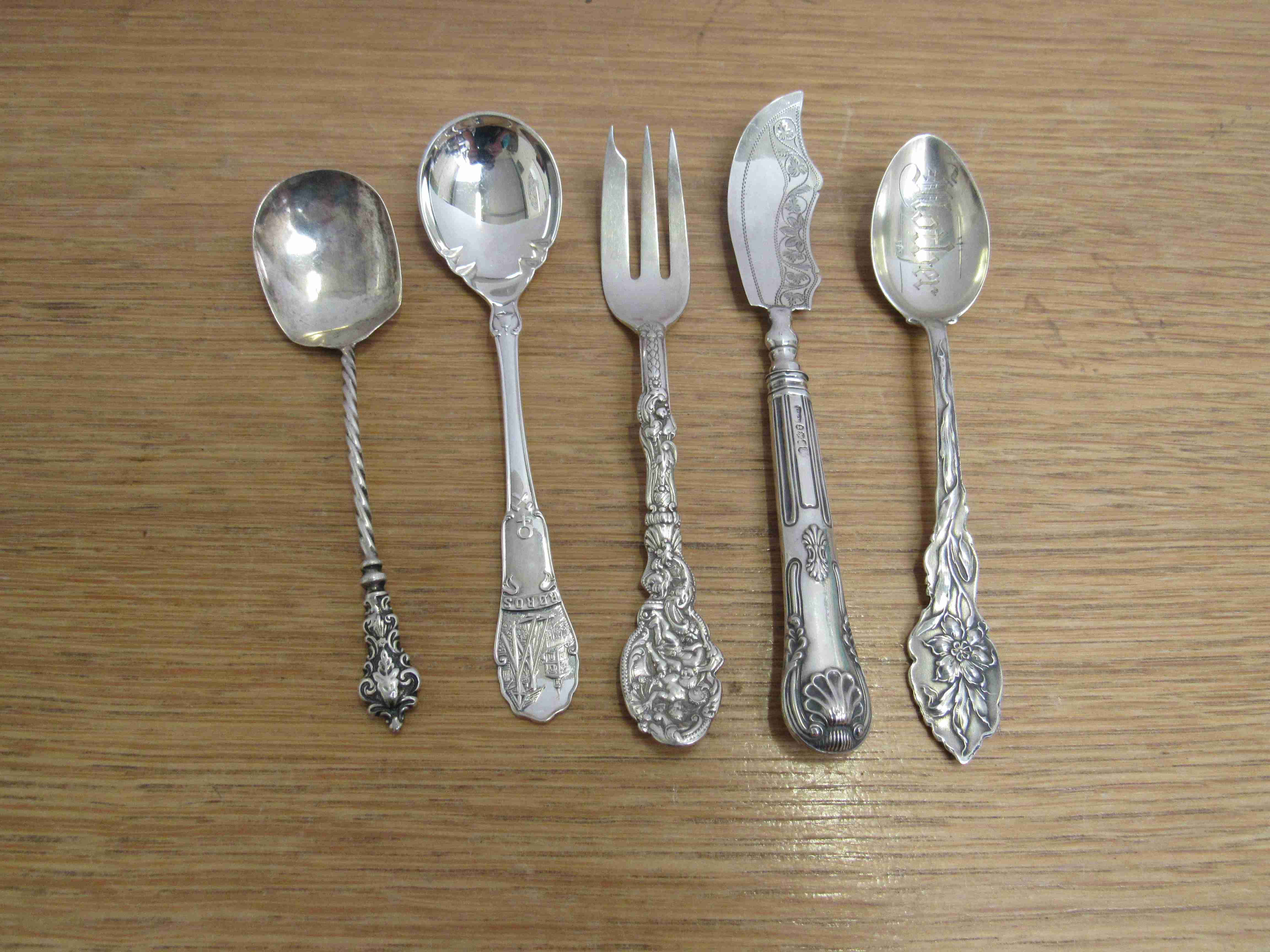 Three decorative silver spoons, fork and knife 121g,