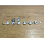 A 9ct gold bracelet with six carved blue cameo panels,