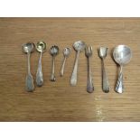 Seven silver various condiment spoons and a fork (8) various makers and dates,