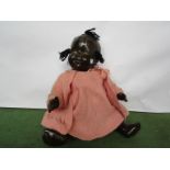 A black composition girl doll on jointed body