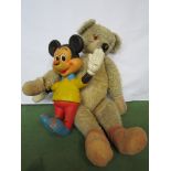 A large care worn jointed bear and a Bendy Mickey Mouse