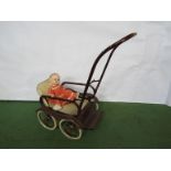 A mid 20th Century Pedigree hard plastic doll and doll's pram