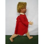 A walking doll in red outfit