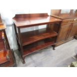 An Edwardian mahogany three-tier buffet, raised on ball and claw feet, top section split, 90cm tall.