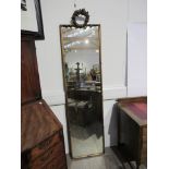 A gilt full-height mirror with garland to top, 197cm x 50cm.