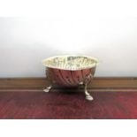 A white metal waiter, 14cm diameter and Vander & Hedges silver embossed bowl on three hoof feet,