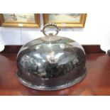 A silver-plate meat dome with crest detail, 51cm long.