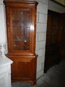 An astragal glazed corner cabinet.