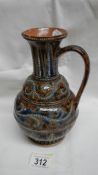 A Doulton Lambeth 1874 jug. Well patterned in blues, whites and browns with raised dots.