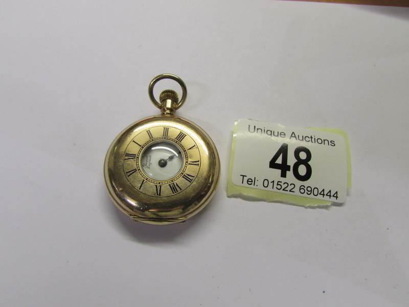 A gold plated pocket watch by the Lancashire Watch Co. (missing one hand).