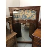 A 19th century mahogany framed mirror with tapestry panel.