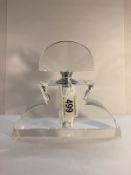 A large art deco style cut glass perfume bottle, 7" high x 7.5" wide.