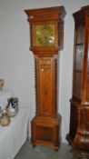 An oak 8 day longcase clock with brass square face