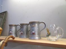 3 armorial metal tankards and a glass example.