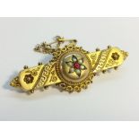 A 9ct gold ruby and pearl brooch with beaded edge and Greek key decorations,