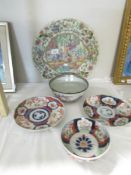 A large oriental charger and 4 other oriental plates and dishes.