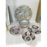 A large oriental charger and 4 other oriental plates and dishes.