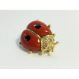 An 18ct yellow gold enamel and diamond ladybug brooch. 4.3 grams.