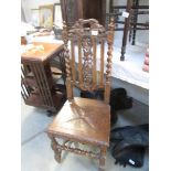 A carved oak hall chair.