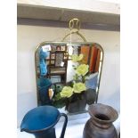 A brass fire screen with painted mirror inset.