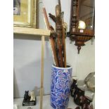 A pottery stick stand with walking sticks.