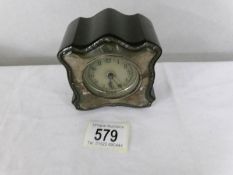 A small silver fronted clock.