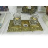 A brass inkstand with 2 glass inkwells.