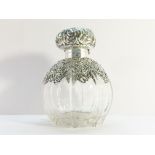 A 1901 scent bottle with silver embossed top and shoulders, Chester 1900/01. (wrong glass stopper).