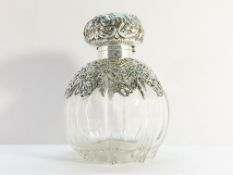 A 1901 scent bottle with silver embossed top and shoulders, Chester 1900/01. (wrong glass stopper).