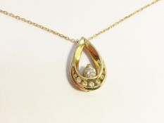 A 14 carat gold and diamond pendant on gold chain.