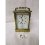 A French brass carriage clock with key.
