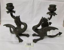 A pair of antique bronze dragon candlesticks.